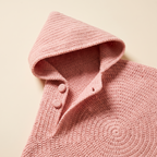 Close-up of the pointed crocheted hood and side opening on a blush pink star baby wrap